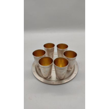 Набор мельхиоровых рюмок с позолотой на подносе.